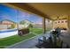 Covered patio with pool and grassy area at 18516 W Sweet Acacia Dr, Goodyear, AZ 85338