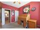 Home office with wooden desk, hockey memorabilia, and bathroom access at 18516 W Sweet Acacia Dr, Goodyear, AZ 85338