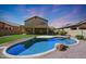 Inviting kidney-shaped pool with grassy backyard and mountain views at 18516 W Sweet Acacia Dr, Goodyear, AZ 85338