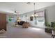 Bright living room with cozy seating and large windows at 18516 W Sweet Acacia Dr, Goodyear, AZ 85338