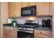 Modern kitchen features stainless steel appliances and dark countertops at 18516 W Sweet Acacia Dr, Goodyear, AZ 85338