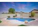 Kidney shaped pool with surrounding landscaping at 18516 W Sweet Acacia Dr, Goodyear, AZ 85338