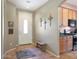 Entryway with tile floor, wooden bench, and kitchen access at 18516 W Sweet Acacia Dr, Goodyear, AZ 85338