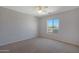 Bedroom with ceiling fan, neutral walls, and carpet at 18516 W Sweet Acacia Dr, Goodyear, AZ 85338