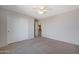 Bedroom with double door closet and ceiling fan at 18516 W Sweet Acacia Dr, Goodyear, AZ 85338