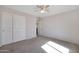 Bedroom with double door closet and ceiling fan at 18516 W Sweet Acacia Dr, Goodyear, AZ 85338