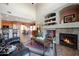 Open Gathering room showcasing a fireplace and kitchen views at 18516 W Sweet Acacia Dr, Goodyear, AZ 85338