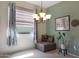 Cozy dining area with window seating, chandelier, and framed art at 18516 W Sweet Acacia Dr, Goodyear, AZ 85338