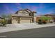 Two-story house with three-car garage and desert landscaping at 18516 W Sweet Acacia Dr, Goodyear, AZ 85338
