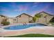 Kidney shaped pool with surrounding landscaping at 18516 W Sweet Acacia Dr, Goodyear, AZ 85338