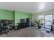 Spacious living area with a home office setup and access to a patio at 3119 W Cochise Dr # 245, Phoenix, AZ 85051