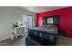 Bedroom with red accent wall and patio access at 3119 W Cochise Dr # 245, Phoenix, AZ 85051