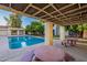 Covered patio with tables and benches by pool at 3119 W Cochise Dr # 245, Phoenix, AZ 85051