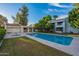 Community pool with grassy area and surrounding trees at 3119 W Cochise Dr # 245, Phoenix, AZ 85051