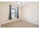 Bright bedroom with carpet, window, and neutral wall colors at 28131 N Marchant Trce, Queen Creek, AZ 85142