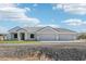 Single-story home with three-car garage and desert landscaping at 28131 N Marchant Trce, Queen Creek, AZ 85142