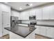 Modern kitchen with white cabinets, island, and stainless steel appliances at 3778 E Santa Fe Ln, Gilbert, AZ 85297