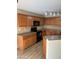 Kitchen with dark wood cabinets, black appliances, and granite countertops at 22839 W Lone Star Dr, Buckeye, AZ 85326