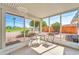 Small patio with table and chairs, overlooking the backyard at 10613 W Connecticut Ave, Sun City, AZ 85351