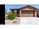 House exterior showcasing a two-car garage and landscaping at 2642 W Hidalgo Ave, Phoenix, AZ 85041