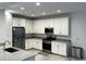 Modern kitchen with white cabinets and island at 2642 W Hidalgo Ave, Phoenix, AZ 85041