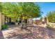 Landscaped courtyard with brick pavers, a central tree, and seating area at 6610 E Barwick Dr, Cave Creek, AZ 85331