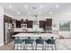 Spacious kitchen with an island, dark wood cabinets, and stainless steel appliances at 2247 E Indian Wells Dr, Gilbert, AZ 85298