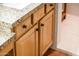 Close-up of wooden bathroom cabinets with granite countertop at 23012 N Giovota Dr, Sun City West, AZ 85375