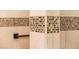Close-up of beige shower tiles with mosaic trim at 23012 N Giovota Dr, Sun City West, AZ 85375