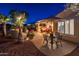 Landscaped backyard with patio furniture and umbrella at 23012 N Giovota Dr, Sun City West, AZ 85375
