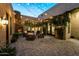 Charming outdoor patio with string lights and fireplace at 8742 E Villa Cassandra Dr, Scottsdale, AZ 85266