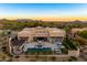 Stunning aerial view of a luxury estate with a pool and desert landscape at 8742 E Villa Cassandra Dr, Scottsdale, AZ 85266