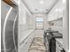 Bright laundry room with white cabinets, quartz countertops, and a modern washer/dryer set at 8742 E Villa Cassandra Dr, Scottsdale, AZ 85266