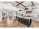 Modern kitchen with large island, white cabinetry, quartz countertops, and hardwood floors at 8742 E Villa Cassandra Dr, Scottsdale, AZ 85266