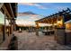 Expansive backyard with a sparkling pool, pergola, and fire pit at 8742 E Villa Cassandra Dr, Scottsdale, AZ 85266