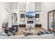 Bright living room features a fireplace and built-ins, hardwood floors, and large windows at 8742 E Villa Cassandra Dr, Scottsdale, AZ 85266
