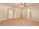 Large bedroom with neutral carpeting, ceiling fan, and ensuite bathroom access at 2705 W Summit Pl, Chandler, AZ 85224