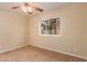 Well-lit bedroom featuring a ceiling fan and carpet flooring at 2705 W Summit Pl, Chandler, AZ 85224