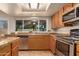 Bright kitchen with stainless steel appliances, granite countertops, and wood cabinets at 2705 W Summit Pl, Chandler, AZ 85224