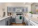 Modern kitchen with gray and white cabinets and a gas stove at 1515 E South Fork Dr, Phoenix, AZ 85048