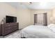 Spacious bedroom with a dresser and a large flat-screen TV at 1515 E South Fork Dr, Phoenix, AZ 85048