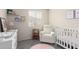 Bedroom featuring a crib, recliner, and changing station at 1515 E South Fork Dr, Phoenix, AZ 85048