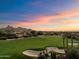 Modern home on golf course with sunset views and mountain backdrop at 10422 E Mark Ln, Scottsdale, AZ 85262