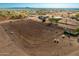 Large riding arena with lights and surrounding desert landscape at 1527 N Wickiup Rd, Apache Junction, AZ 85119