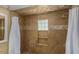 Bathroom with tile shower, built-in shelves, and white vanity at 5850 W Cheery Lynn Rd, Phoenix, AZ 85031