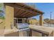 Outdoor kitchen with built-in grill, covered patio, and mini-fridge at 5850 W Cheery Lynn Rd, Phoenix, AZ 85031