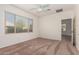 Bright bedroom with large window and ceiling fan at 12948 W El Sueno Ct, Sun City West, AZ 85375