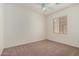 Spacious bedroom with ceiling fan and neutral carpet at 12948 W El Sueno Ct, Sun City West, AZ 85375