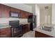 Well-equipped kitchen featuring dark wood cabinets and granite countertops at 727 W Judi Dr, Casa Grande, AZ 85122