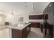 Open kitchen with granite island and dark wood cabinets at 727 W Judi Dr, Casa Grande, AZ 85122